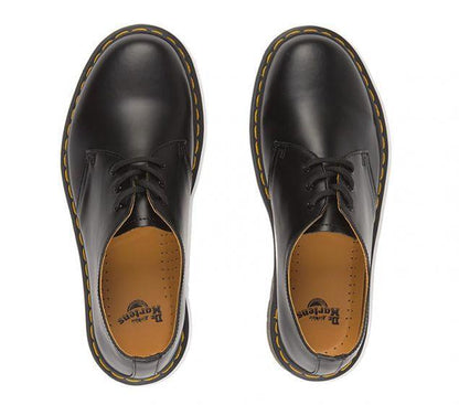 Make a statement with the iconic Dr Marten's 1461Z DMC 3-Eye shoe. Stamped with Docs trademade look, this lace-up shoe is crafted with high-quality, durable smooth lDR MARTENS | 1461 DMC 3-EYE SHOE | BLACK SMOOTH